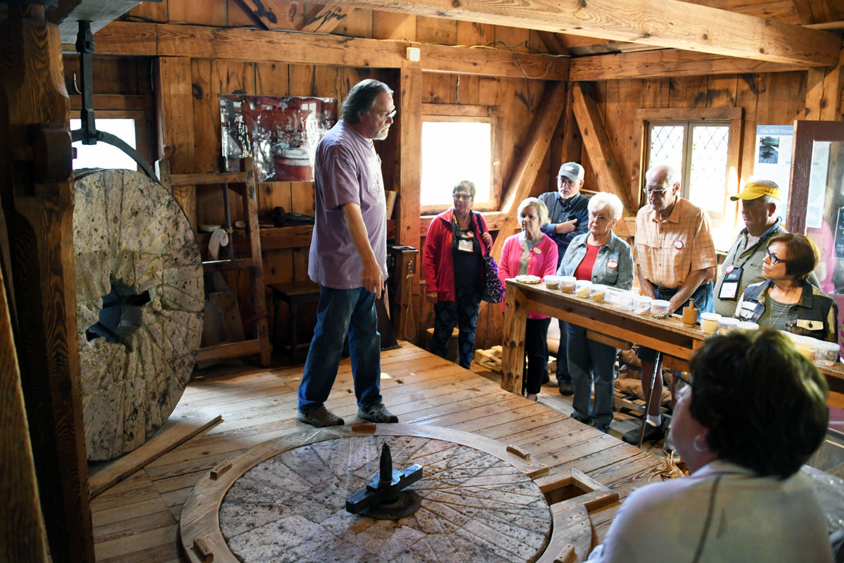 013 The Fun Club learns about the grinding wheel used at the gristmill.jpg